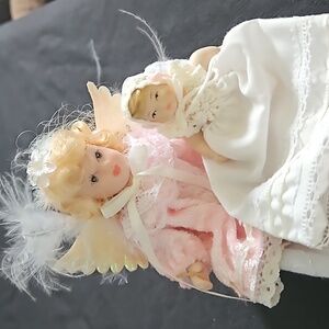 Two porcelain dolls and bed 3 pieces